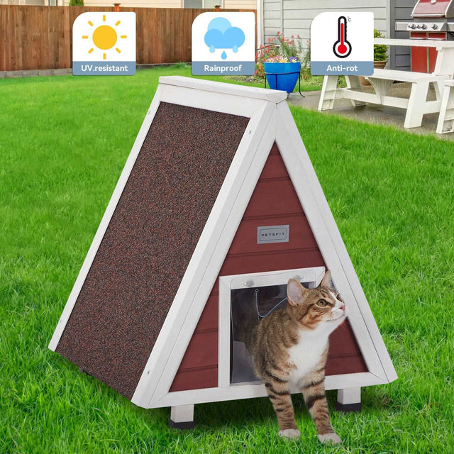 Outdoor cat house placed on backyard grass with a tabby at the entrance, emphasizing UV-resistant, rainproof, anti-rot build.