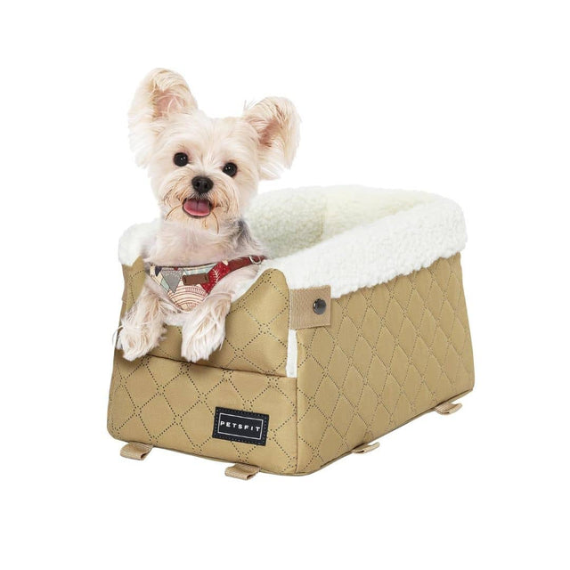 Tiny terrier peeks from a beige quilted booster seat for dogs with cozy white lining, ears perked and paws forward.