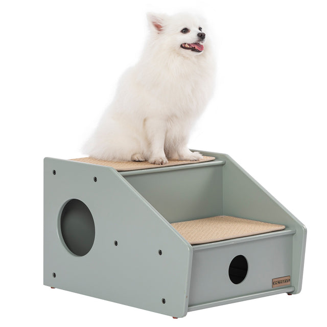 White Spitz dog sitting on top of PETSFIT sage green 2-step wooden pet stairs with beige sisal mats and round side opening, white background