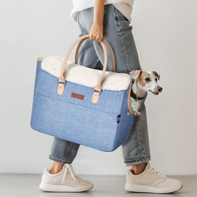 Pet owner carrying PETSFIT denim pet tote outdoors with small dog inside