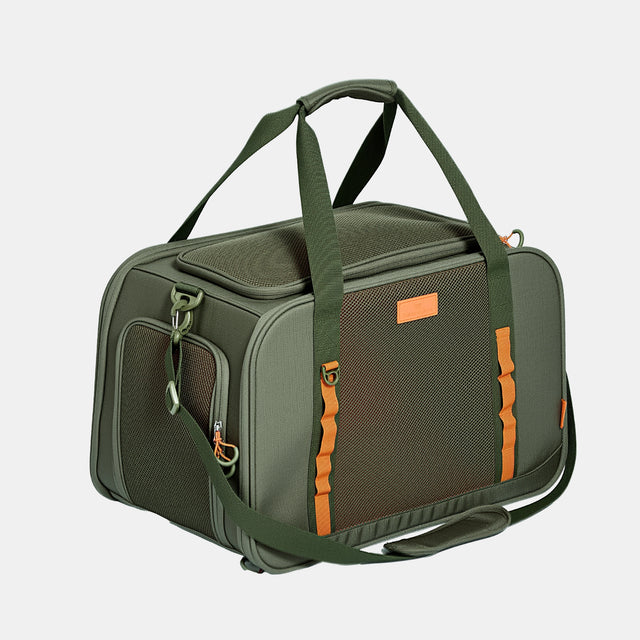 Olive green pet carrier at three-quarter angle with orange accent straps, mesh side panel, dual top handles and shoulder strap