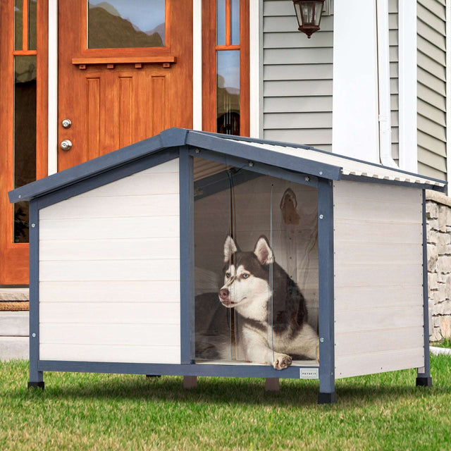 Spacious and weather-resistant PETSFIT Outdoor Dog House with a PVC roof, plastic door flap, and raised adjustable feet for all-weather protection.