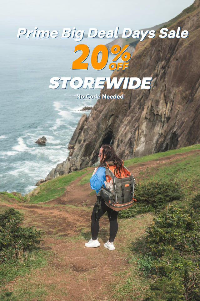 Prime Big Deal Days 20% off banner: woman on a coastal cliff trail above the ocean carrying a cat in a pet backpack (mobile version)