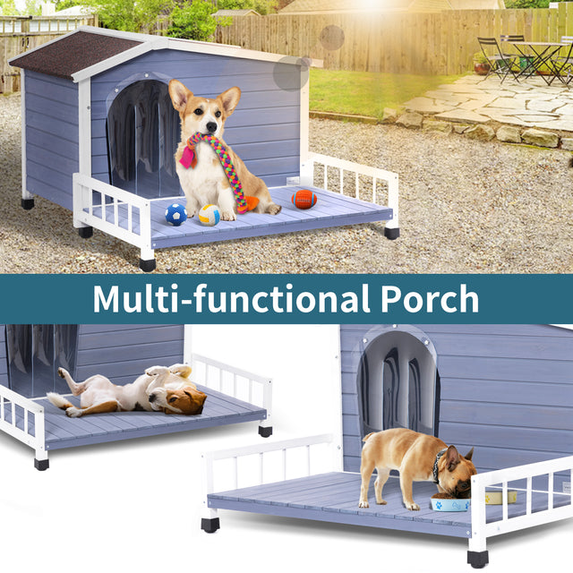 Corgi with rope toy sits on the porch deck of a blue outdoor dog house in a sunny backyard with balls and open space.