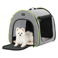 Fluffy white puppy lounges at the open entrance of a gray soft dog crate with breathable mesh panels and cushioned mat.