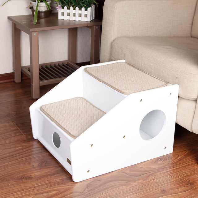 PETSFIT white 2-step wooden pet stairs with beige sisal mats next to sofa in living room, showing hollow side panels and non-slip base