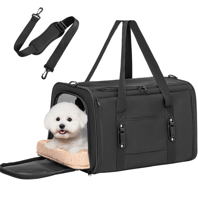 Black dog carrier with front flap open and plush bed holds a small white dog, plus removable shoulder strap attachment.