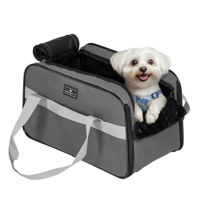 Small dog sitting comfortably in PETSFIT console dog car seat installed in center console of SUV during road trip