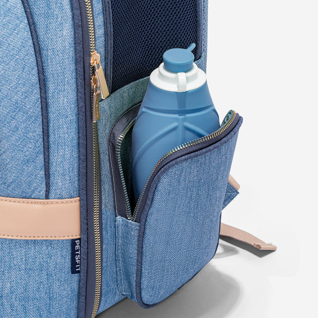 Side compartment unzipped to hold a collapsible water bottle, showing handy storage for walks, hikes, and day trips