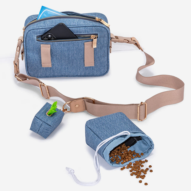 PETSFIT denim dog walking bag detail showing gold zipper, PETSFIT leather badge, treat pocket and poop bag holder on front panel