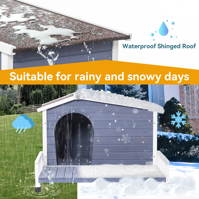 Weatherproof dog house with waterproof shingled roof shown in rain and snow, keeping the elevated porch and entry area drier.