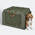 Army green soft dog crate on white background, mesh front panel and orange rope handles, beagle standing at the open door